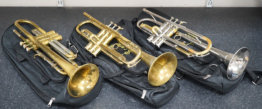 Three student trumpets by Beltone, etc. in soft cases and a cased Boosey & Hawkes trombone. Condition - poor to fair, all play